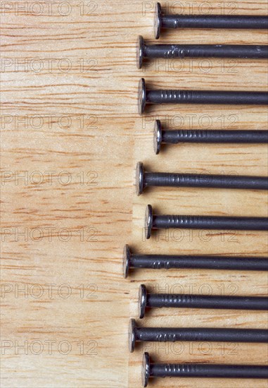 Macro of nails on a wood background