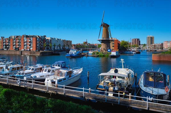 View of the harbour of Delfshaven with the old grain mill known as De Destilleerketel