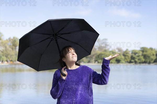 Latin woman with umbrella on a sunny day