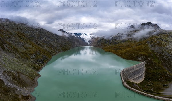 Aerial view of the Oberaar reservoir with the Oberaar glacier and the Bernese Alps