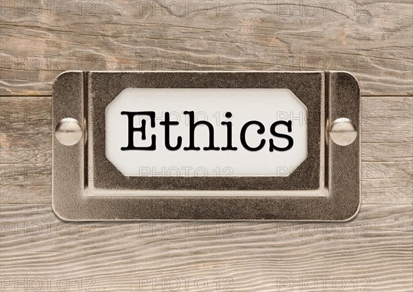 Ethics metal file label frame on wood background