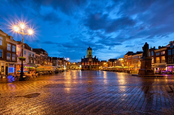 Delft City Hall and Delft Market Square Markt with Hugo de Groot Monument in the evening. Delfth