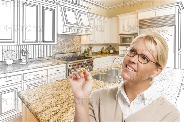 Creative woman with pencil over custom kitchen design drawing and photo combination