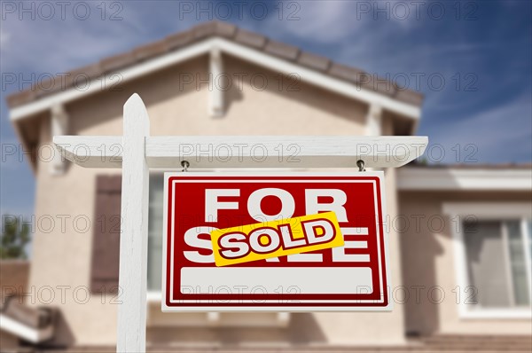 Sold home for sale real estate sign and house