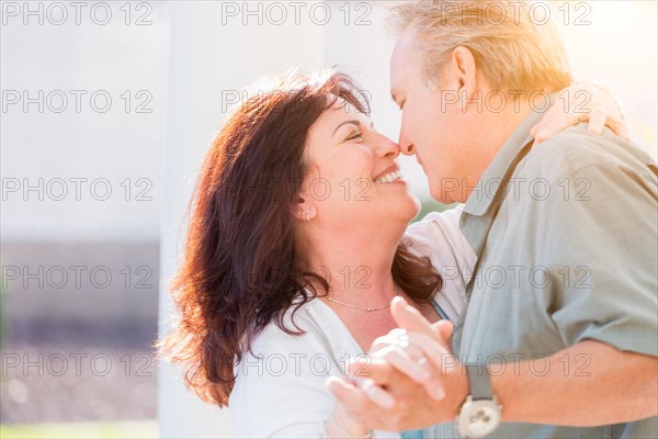 Happy middle aged couple enjoy A romantic slow dance outside