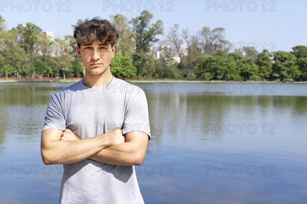 Portrait of confident young blond man with crossed arms looking at camera