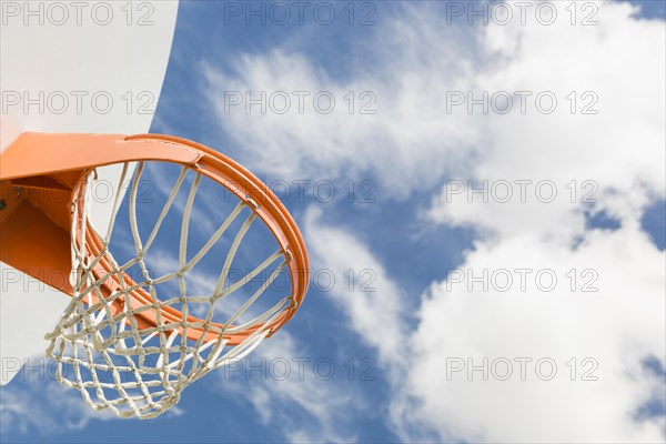 Abstract of community basketball hoop and net against blue sky