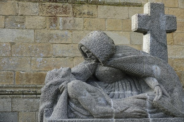 Modern granite Pieta in front of the Gothic cathedral of Saint-Paul Aurelien