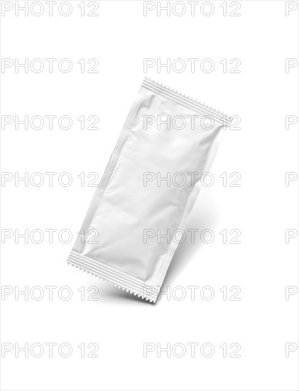 Blank white condiment packet floating isolated on white background