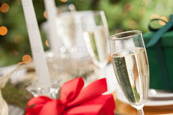 Champagne glass and christmas gift with place setting abstract at table