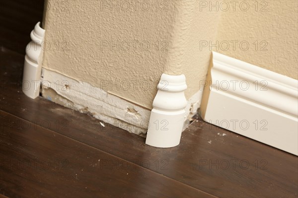 New baseboard and bull nose corners with laminate flooring abstract