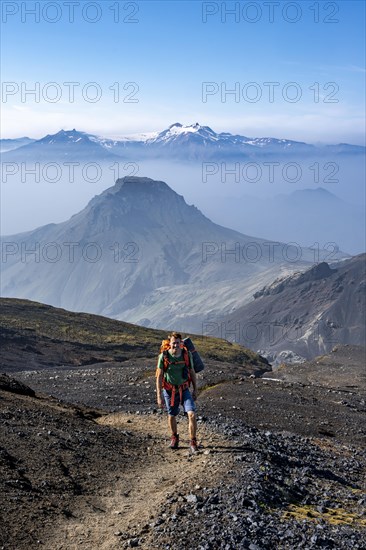 Hikers on hiking trail through volcanic landscape