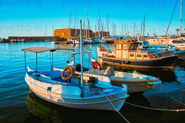 Venetian Fort Venetian fortress of Koules Castello in Heraklion and moored Greek fishing boats in port