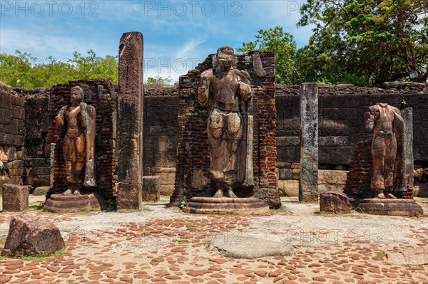 Standing Buddha statue in ancient ruins