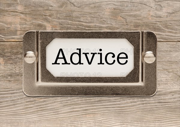 Advice metal file label frame on wood background