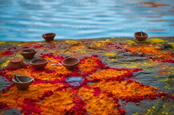 Oil Lamp Pooja Diya Lamp and kumkum powder flower and on ghats after pooja in Jodhpur