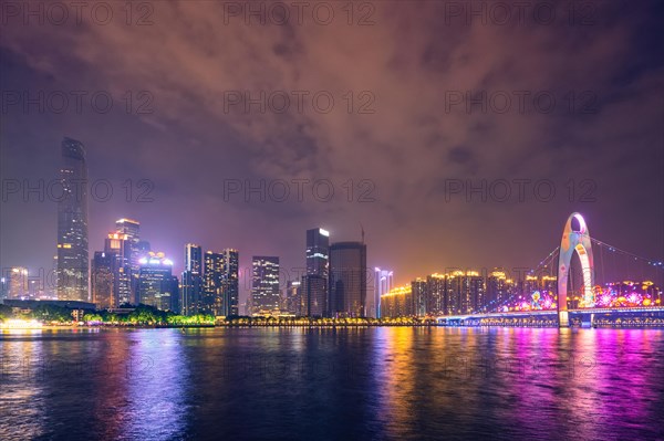 Guangzhou cityscape skyline over the Pearl River illuminated in the evening. Guangzhou