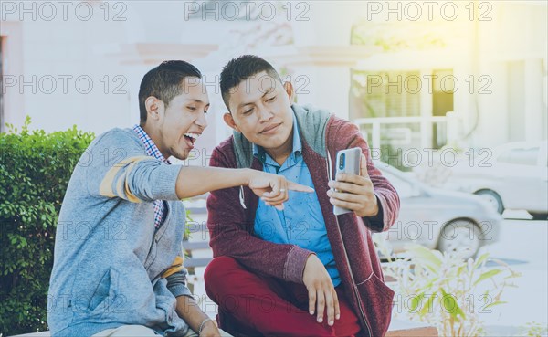 Man showing his cell phone to another man