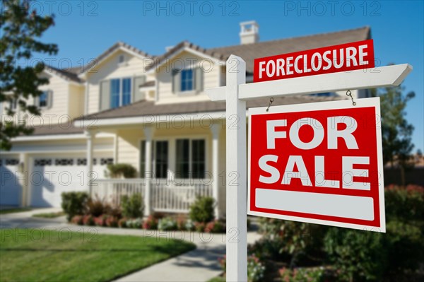 Foreclosure home for sale real estate sign in front of new house