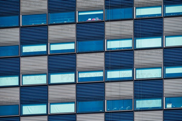 Modern building blue and white facade with widnows close up