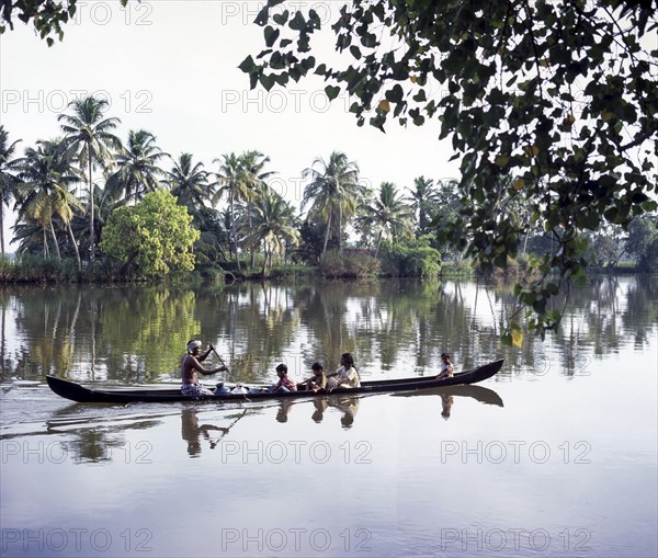 Children being taken in a boat across the back waters of Alappuzha or Alleppey in Kerala