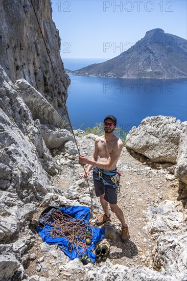 Climber belays on the ground