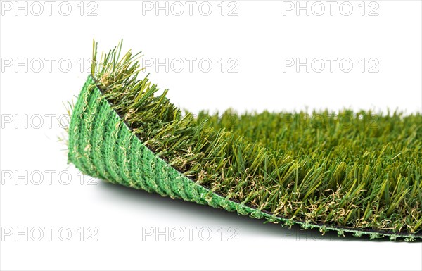 Flipped up section of artificial turf grass on white background