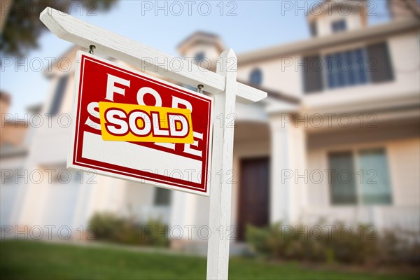 Home for sale real estate sign in front of new house