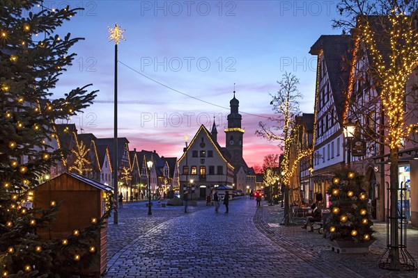 Christmas illuminated market place with old town hall and St. John's church in the evening