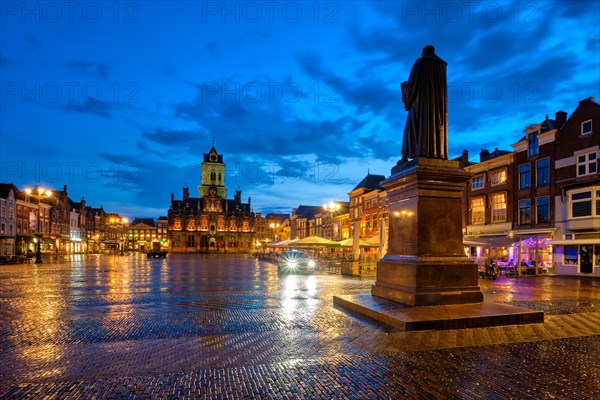 Delft City Hall and Delft Market Square Markt with Hugo de Groot Monument in the evening