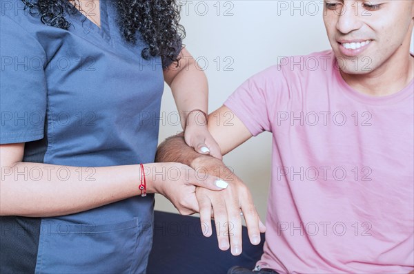 Physiotherapist with patient wrist assessment