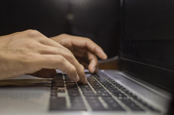 Hands on laptop keyboard