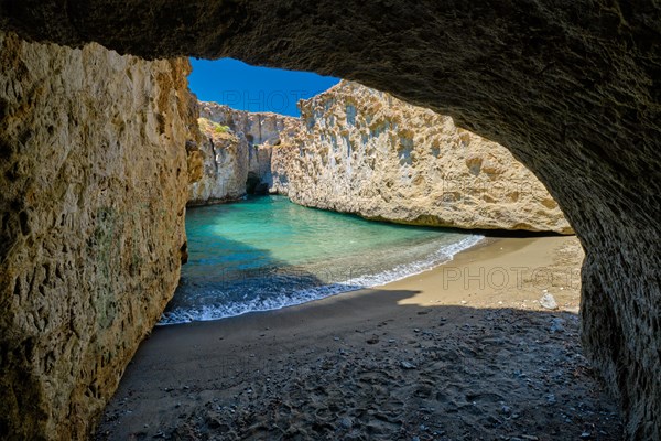 Papafragas hidden beach with crystal clear turquoise water and tunnel rock formations in Milos island