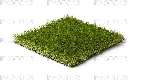 Section of artificial turf grass isolated on white background