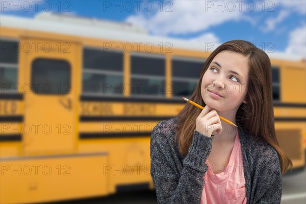 Young female student near school bus