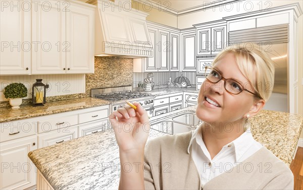 Creative woman with pencil over custom kitchen design drawing and photo combination