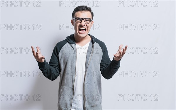 Young man with open hands screaming angry to the camera