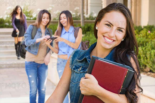 mixed-race young girl student with school books on campus