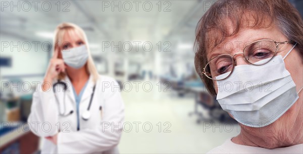 Senior adult female looking down as doctor stands behind all wearing medical face masks within hospital