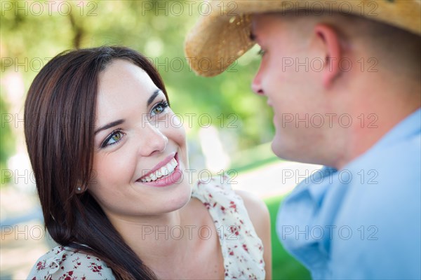 Happy romantic caucasian couple talking in the park