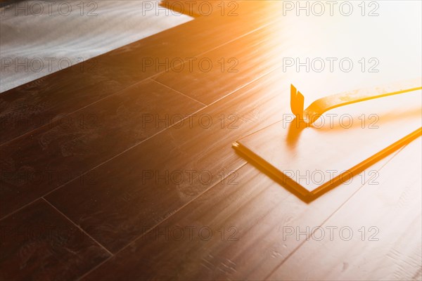 Pry bar tool with new laminate flooring abstract