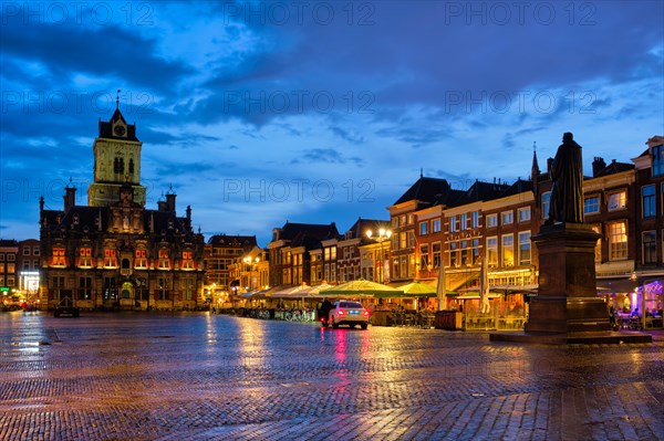 Delft City Hall and Delft Market Square Markt with Hugo de Groot Monument in the evening