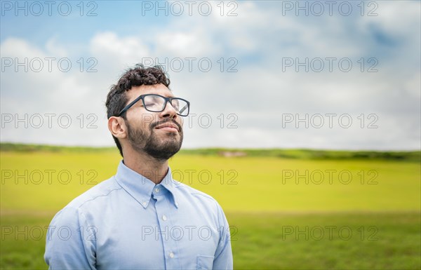 A young person breathing fresh air in the field