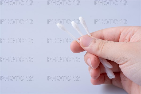 A few ear sticks in hand isolated on white background