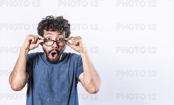 Surprised glasses man holding his glasses