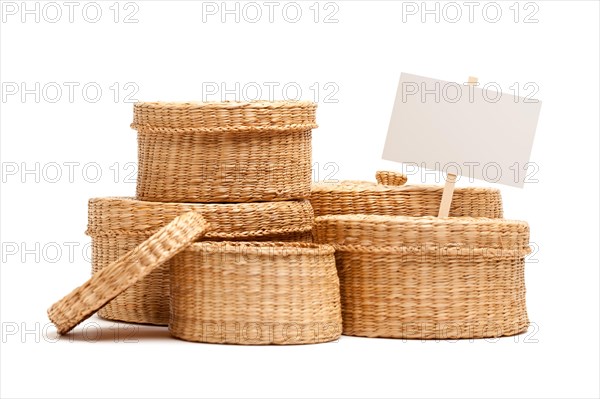 Various sized wicker baskets with blank sign isolated on white