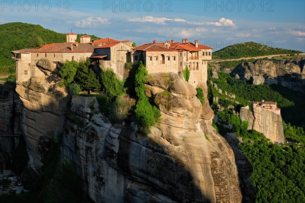 Monastery of Varlaam monastery and Monastery of Rousanou in famous greek tourist destination Meteora in Greece on sunset with scenic scenery landscape