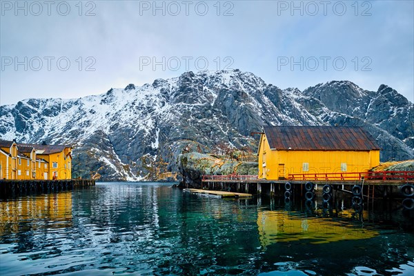 Nusfjord authentic fishing village in winter with red rorbu houses. Lofoten islands