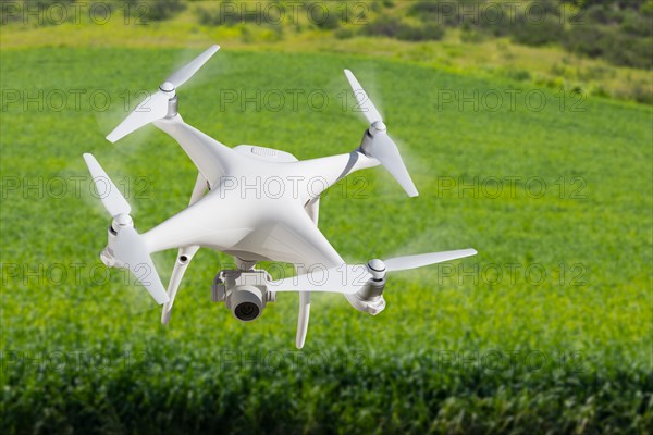 Drone unmanned aircraft flying and gathering data over country farmland