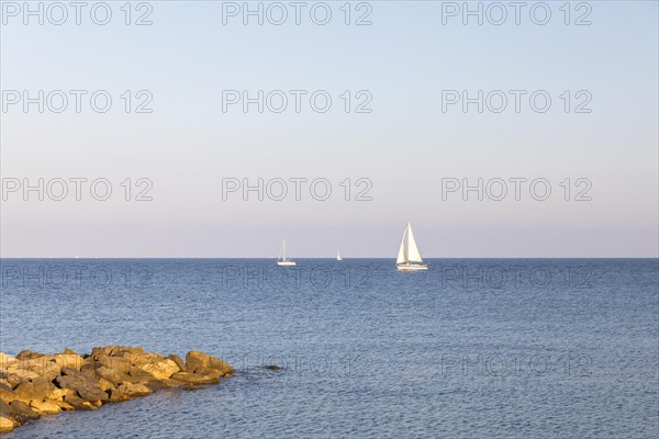 Rocky coast with sailboat in San Lorenzo al Mare